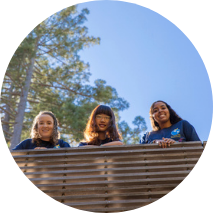 Students on a bridge, redwood trees in background