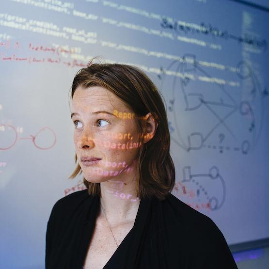 Student with whiteboard in background